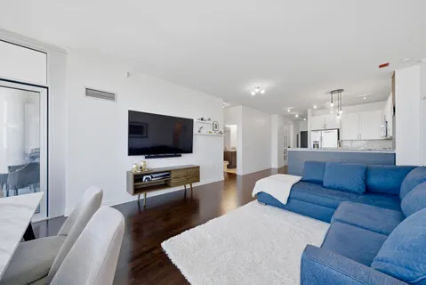 a kitchen with stainless steel appliances granite countertop a stove a microwave and a white cabinets