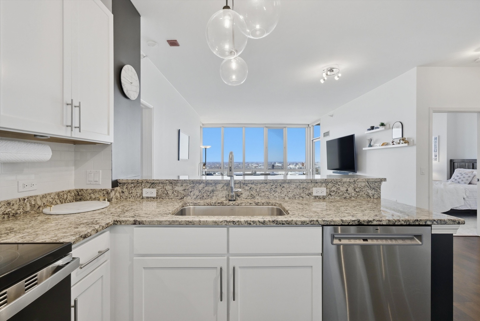 1629 South Prairie Avenue, Unit 2709 Chicago, IL 60616 - Photo 19 of 37 a kitchen with kitchen island granite countertop a sink a counter space and cabinets