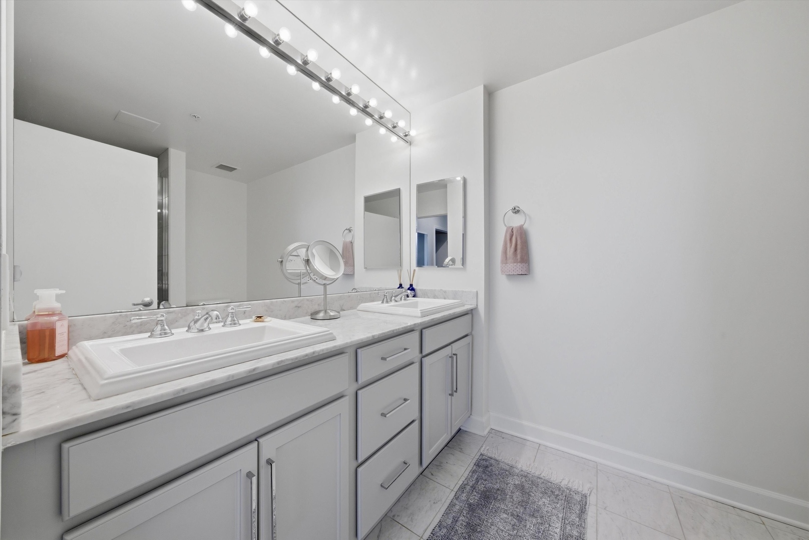 1629 South Prairie Avenue, Unit 2709 Chicago, IL 60616 - Photo 22 of 37 a bathroom with a double vanity sink and a mirror