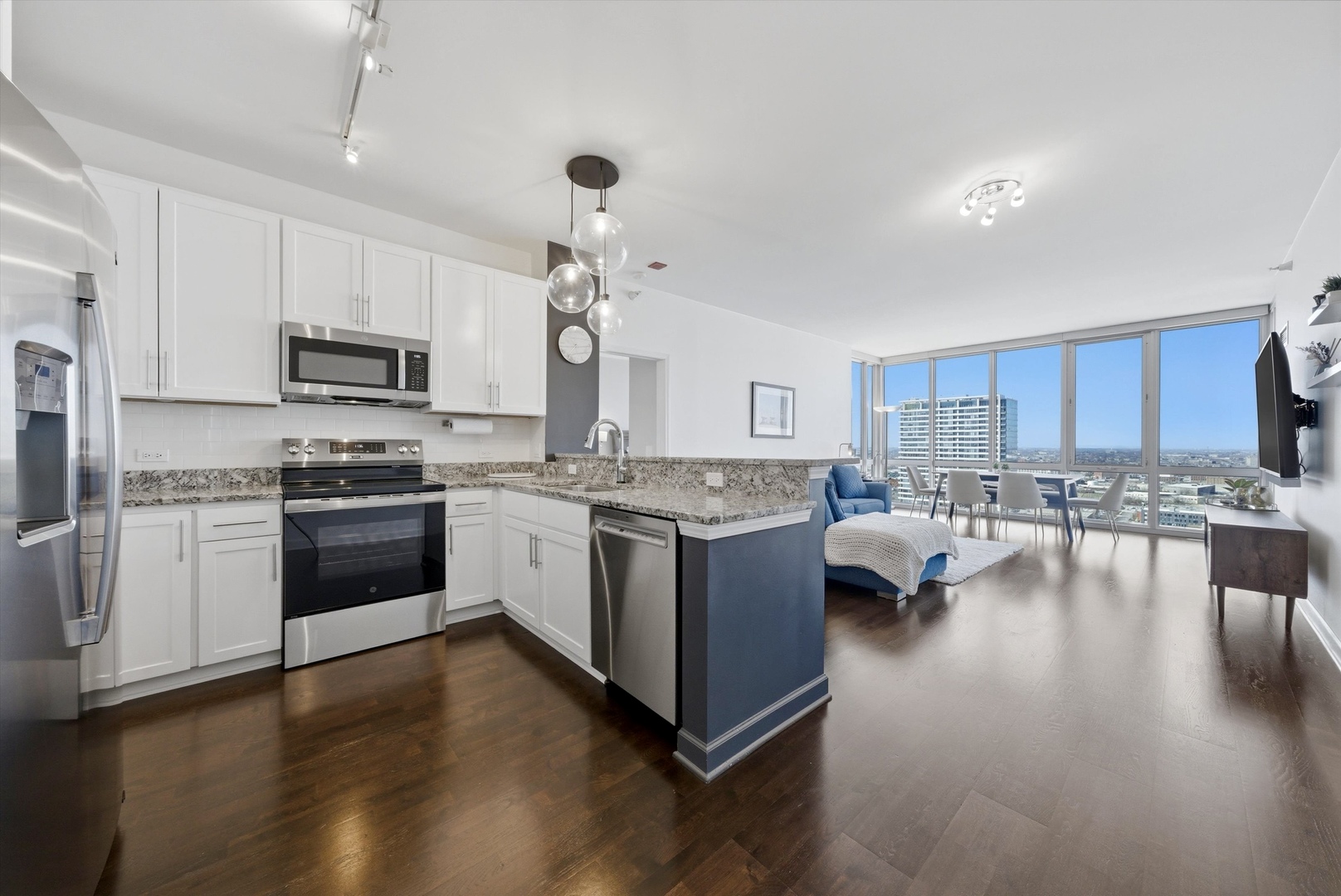 1629 South Prairie Avenue, Unit 2709 Chicago, IL 60616 - Photo 3 of 37 a kitchen with granite countertop stainless steel appliances and view living room