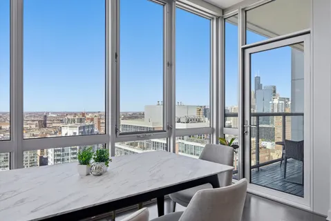 a view of a balcony with chairs and a potted plant