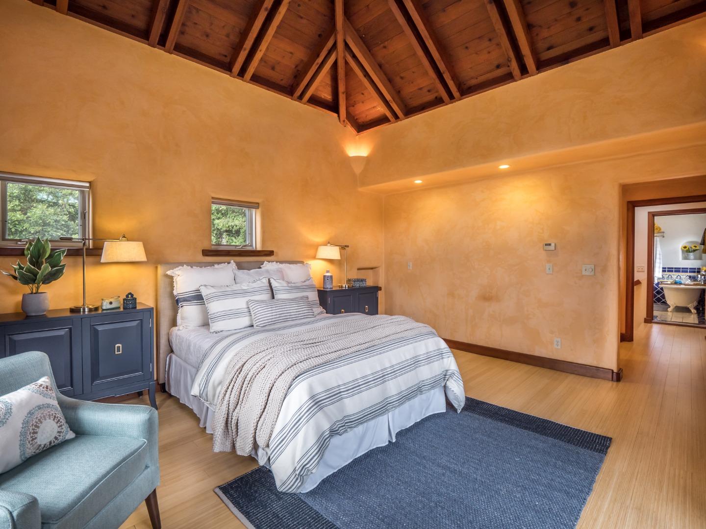 700 Enos Lane Watsonville, CA 95076 - Photo 21 of 56 a bedroom with a bed and wooden floor