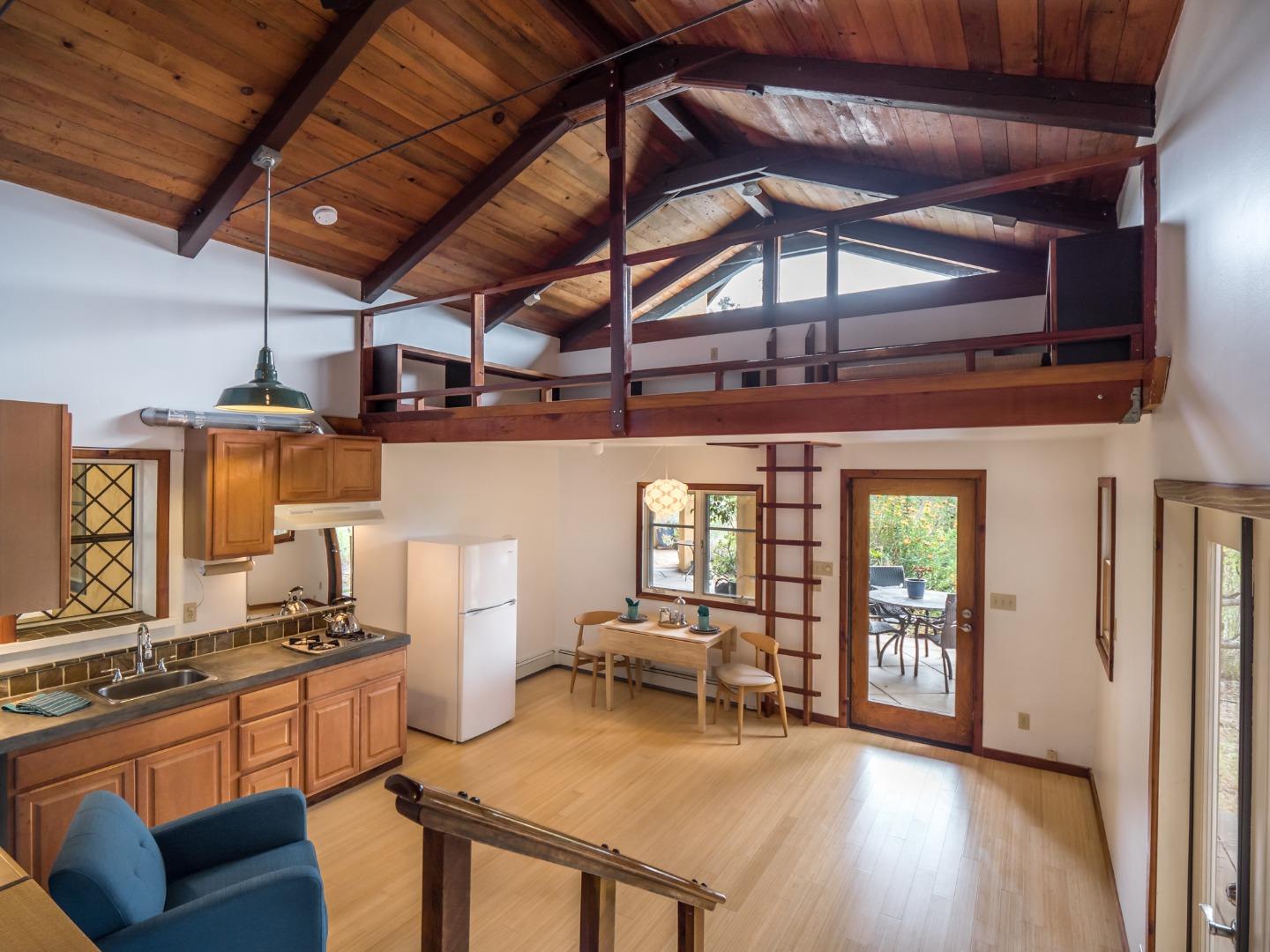 700 Enos Lane Watsonville, CA 95076 - Photo 28 of 56 a kitchen with a stove a refrigerator and wooden floor