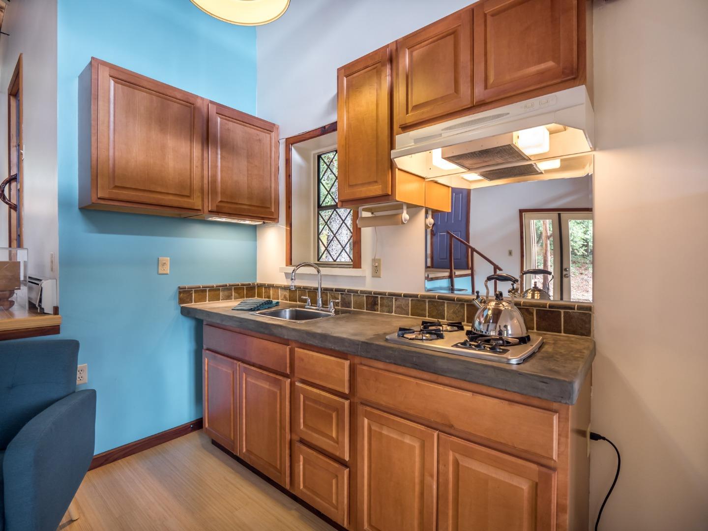 700 Enos Lane Watsonville, CA 95076 - Photo 29 of 56 a kitchen with stainless steel appliances granite countertop a sink stove and cabinets