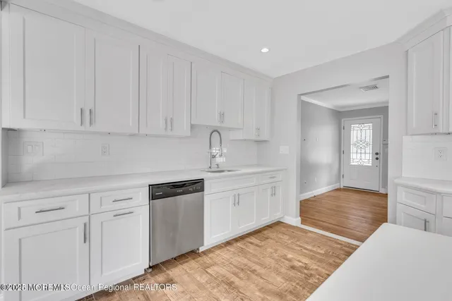 a kitchen with white cabinets and white appliances