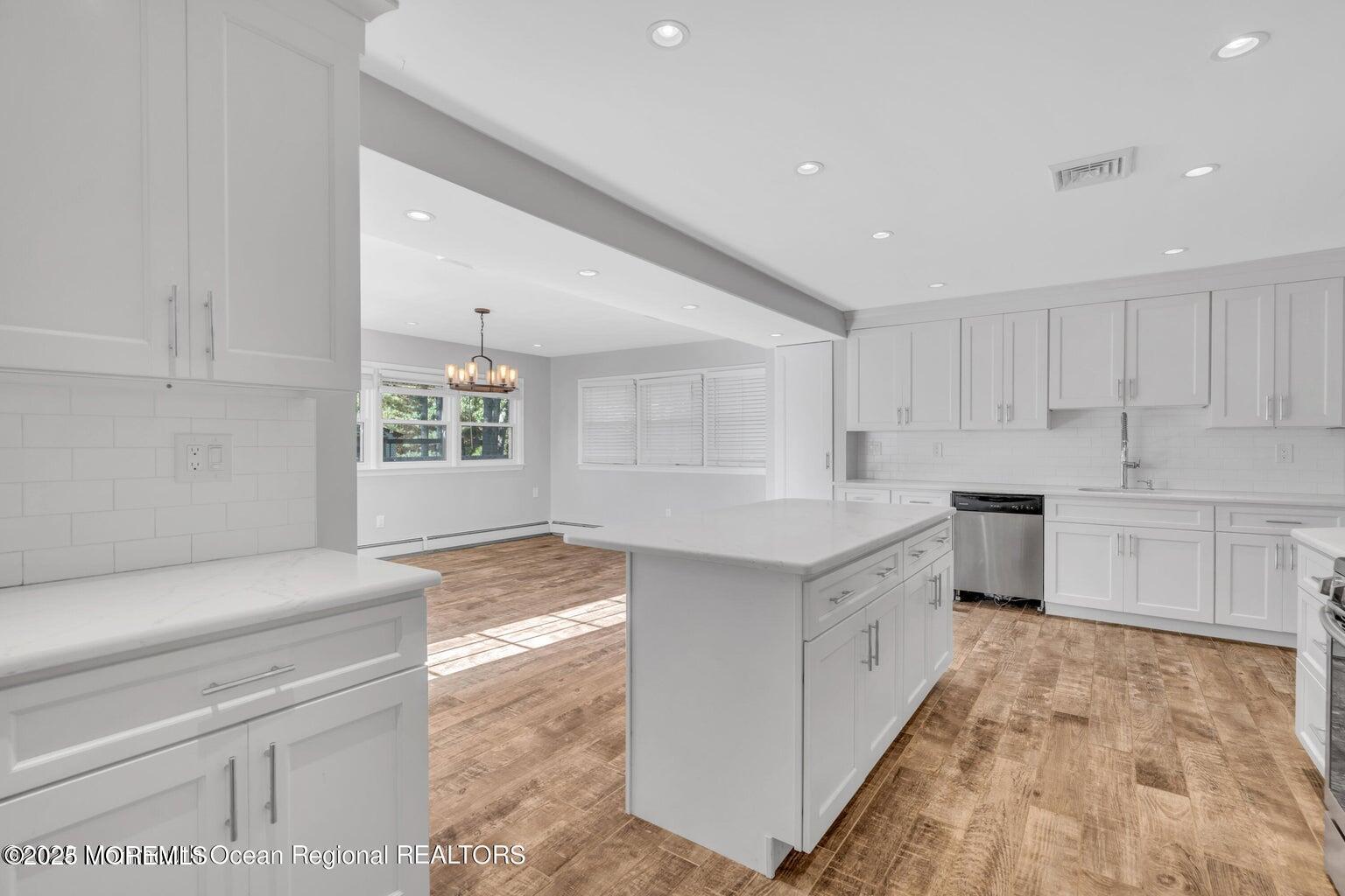 2253 Llewellyn Parkway Forked River, NJ 08731 - Photo 13 of 42 a kitchen with white cabinets and white appliances