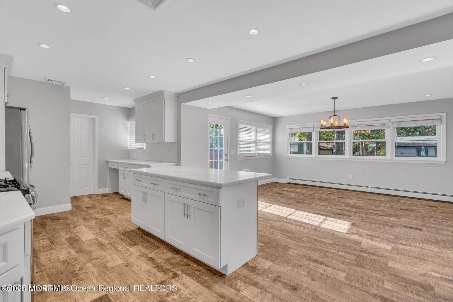 2253 Llewellyn Parkway Forked River, NJ 08731 - Photo 14 of 42 a large white kitchen with granite countertop a stove and a sink