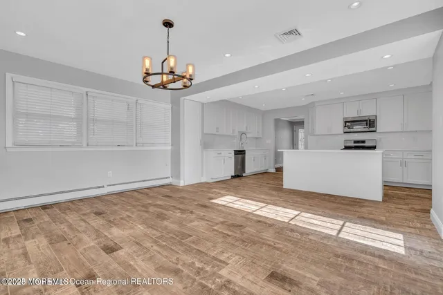a kitchen with stainless steel appliances a refrigerator and a stove top oven