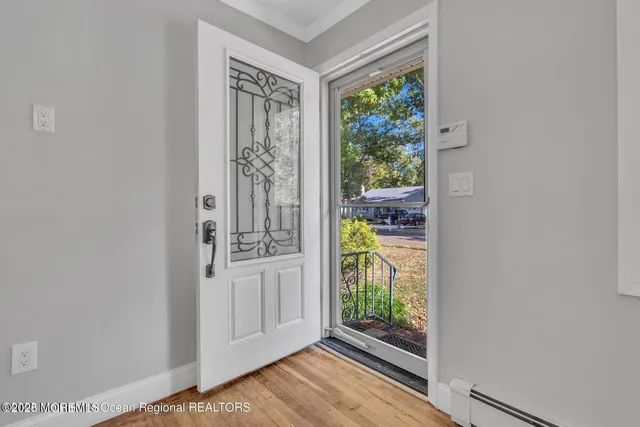 a view of an entryway with wooden floor