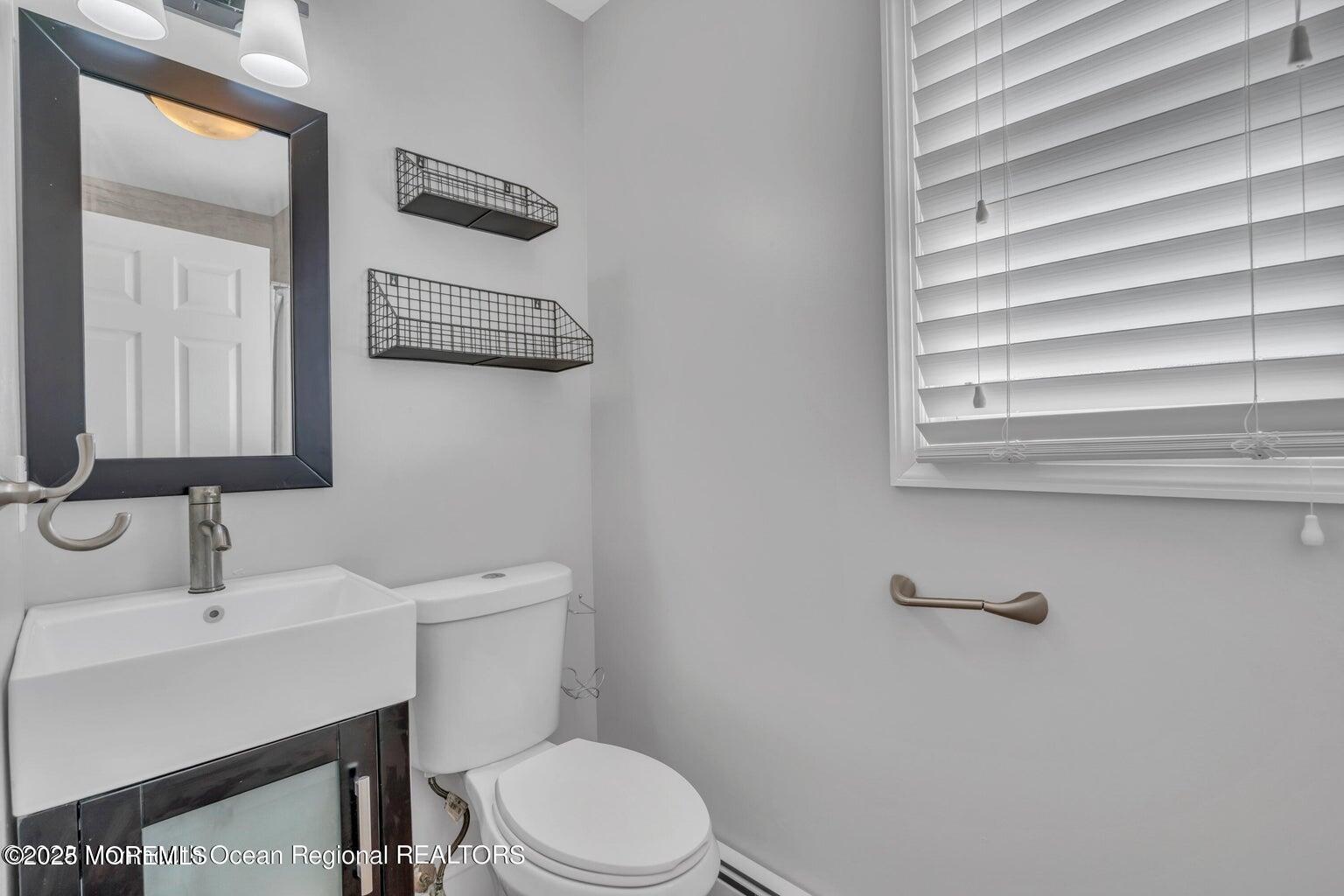 2253 Llewellyn Parkway Forked River, NJ 08731 - Photo 23 of 42 a bathroom with a sink a mirror and a toilet
