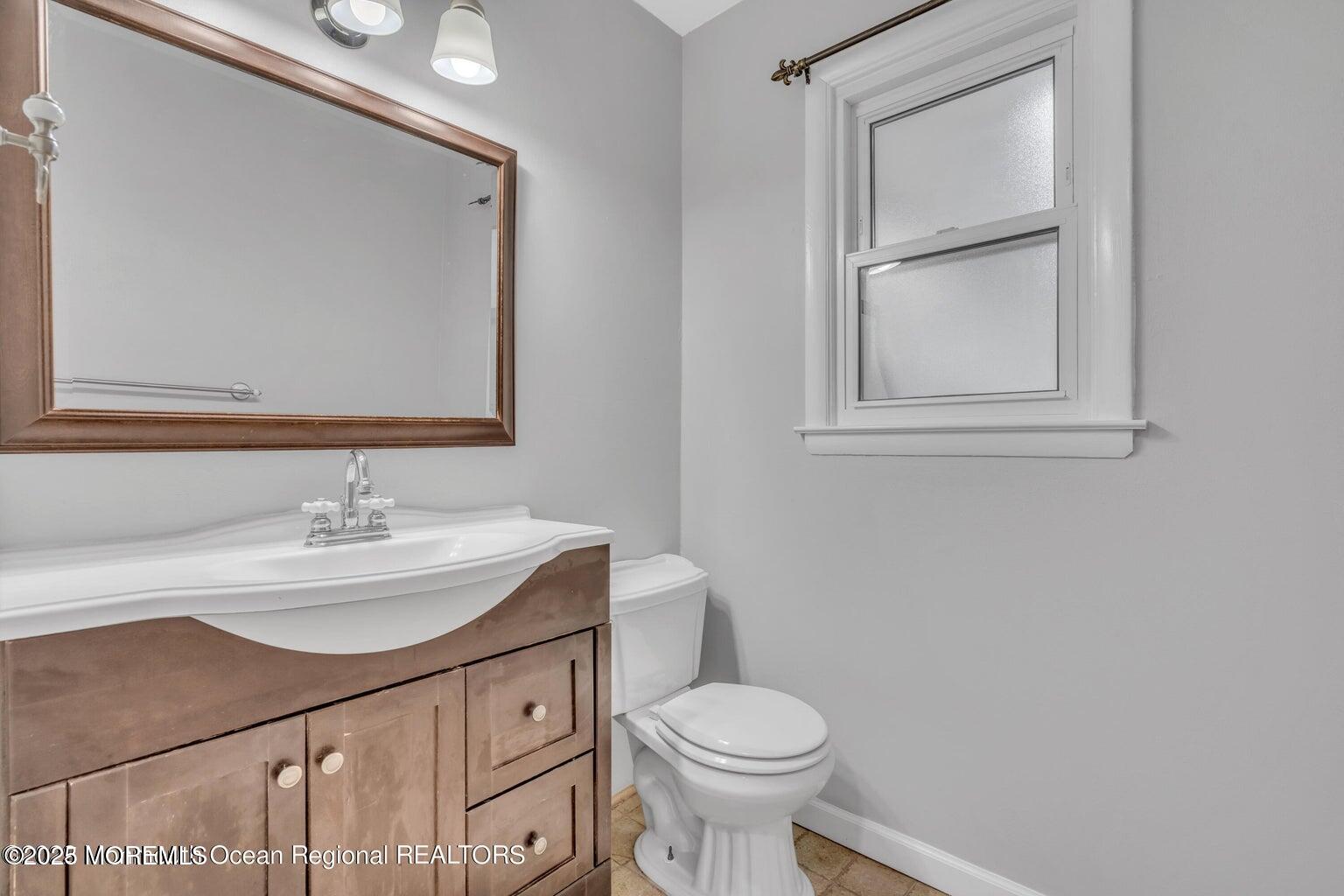 2253 Llewellyn Parkway Forked River, NJ 08731 - Photo 25 of 42 a bathroom with a sink a toilet and mirror