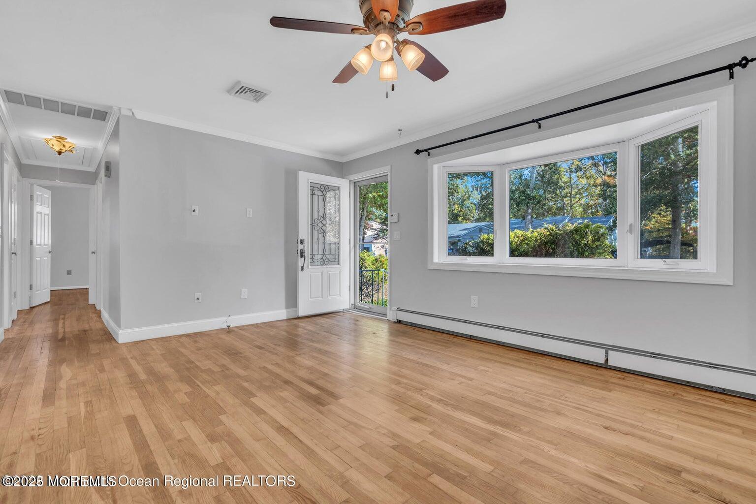 2253 Llewellyn Parkway Forked River, NJ 08731 - Photo 3 of 42 a view of an empty room with wooden floor and a window