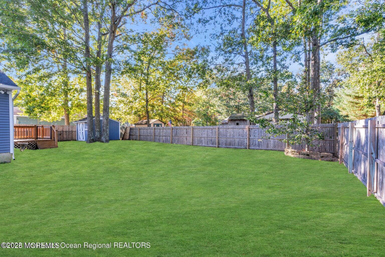 2253 Llewellyn Parkway Forked River, NJ 08731 - Photo 34 of 42 a view of yard with trees and wooden fence