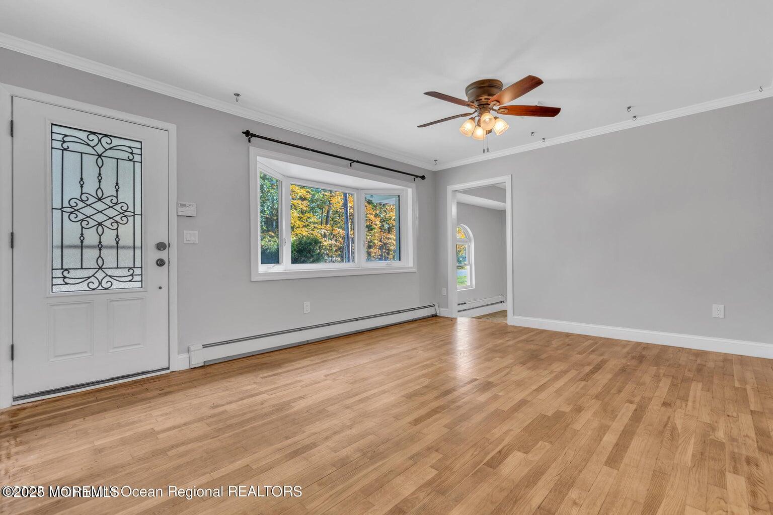 2253 Llewellyn Parkway Forked River, NJ 08731 - Photo 4 of 42 a view of an empty room with a window and wooden floor