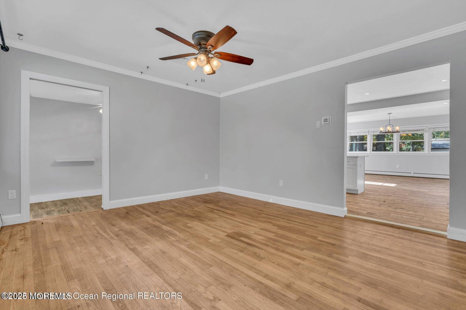 2253 Llewellyn Parkway Forked River, NJ 08731 - Photo 5 of 42 an empty room with wooden floor and windows