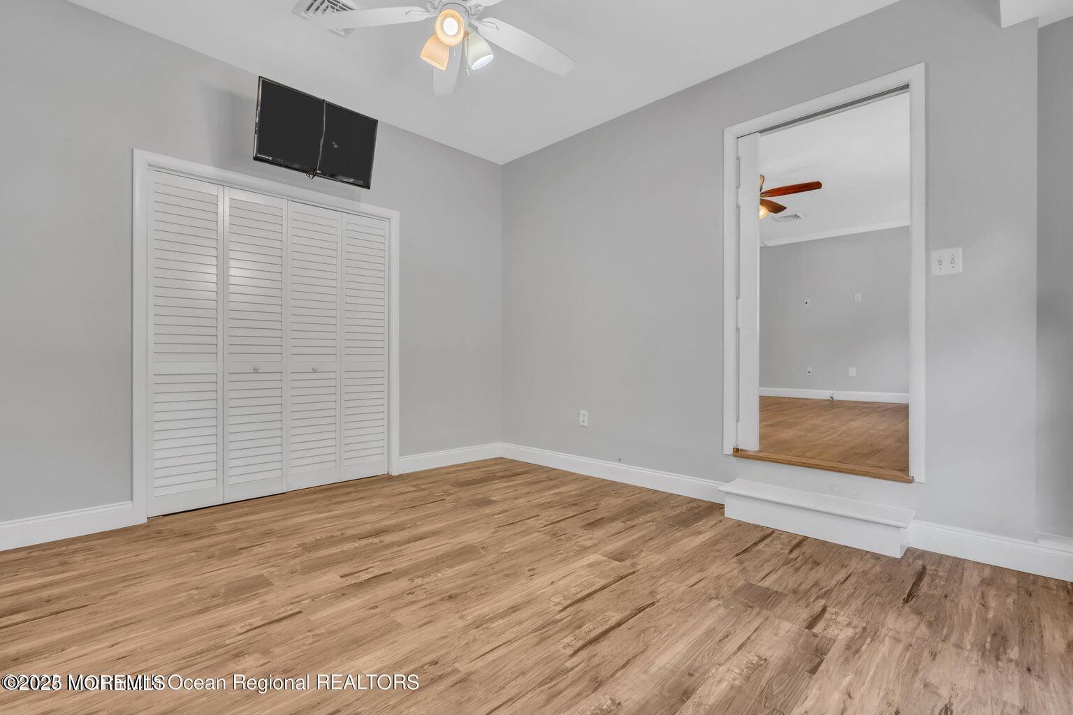 2253 Llewellyn Parkway Forked River, NJ 08731 - Photo 7 of 42 a view of an empty room with wooden floor and a window