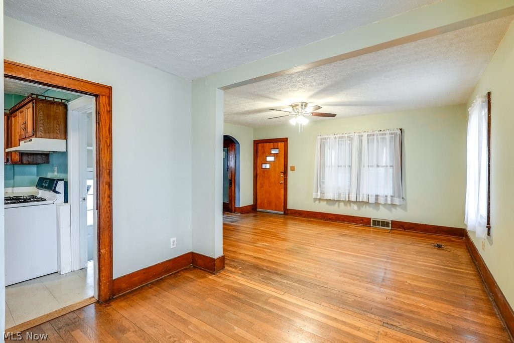 851 Ranney Street Akron, OH 44310 - Photo 17 of 30 Tiled empty room featuring ceiling fan and a textured ceiling