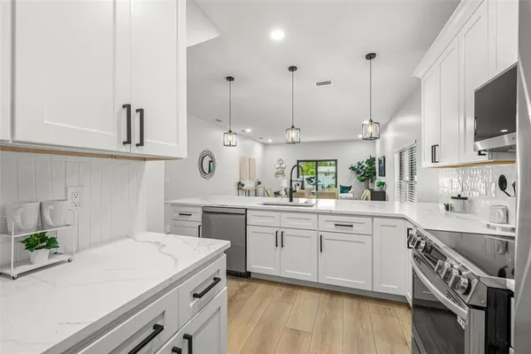 a kitchen with a refrigerator and a sink