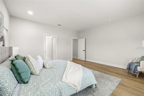 a spacious bathroom with a double vanity sink toilet mirror and shower