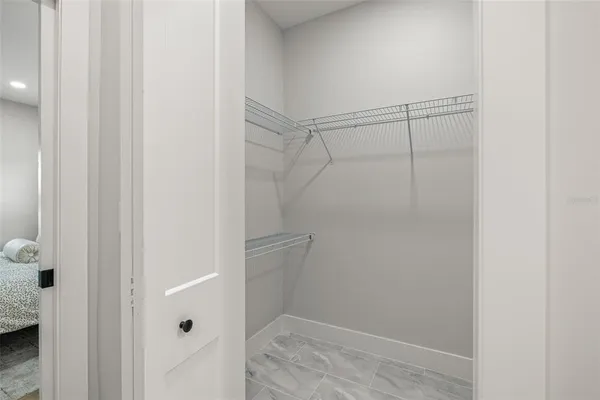 a view of a hallway with stainless steel appliances