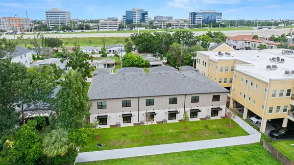 a aerial view of a house with a yard table and chair