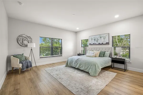 a large kitchen with stainless steel appliances granite countertop a stove and a wooden floors