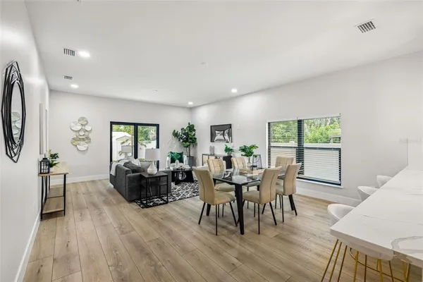 a living room with furniture kitchen and a table