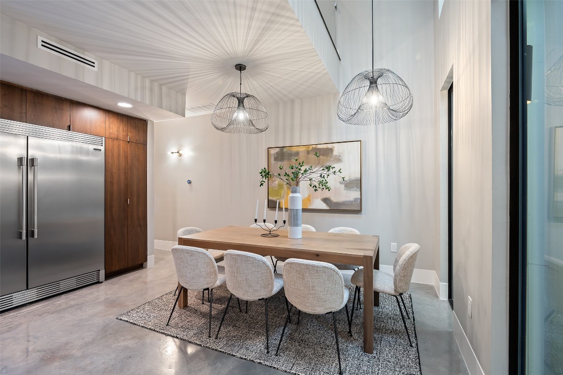 1327 Bonham Terrace, Unit B Austin, TX 78704 - Photo 15 of 40 a view of a dining room with furniture a chandelier and wooden floor