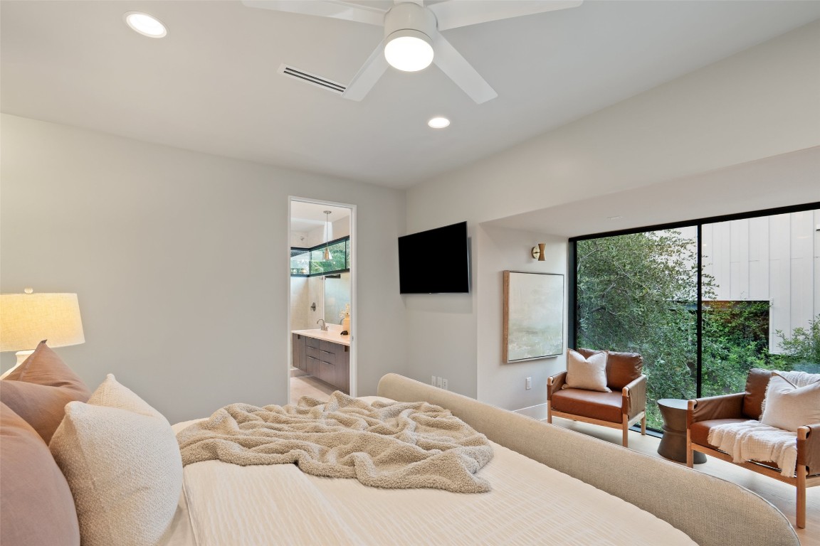 1327 Bonham Terrace, Unit B Austin, TX 78704 - Photo 21 of 40 a bedroom with a bed and large windows