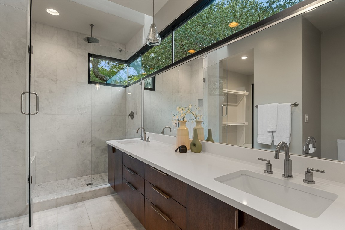 1327 Bonham Terrace, Unit B Austin, TX 78704 - Photo 22 of 40 a bathroom with a double vanity sink mirror and shower