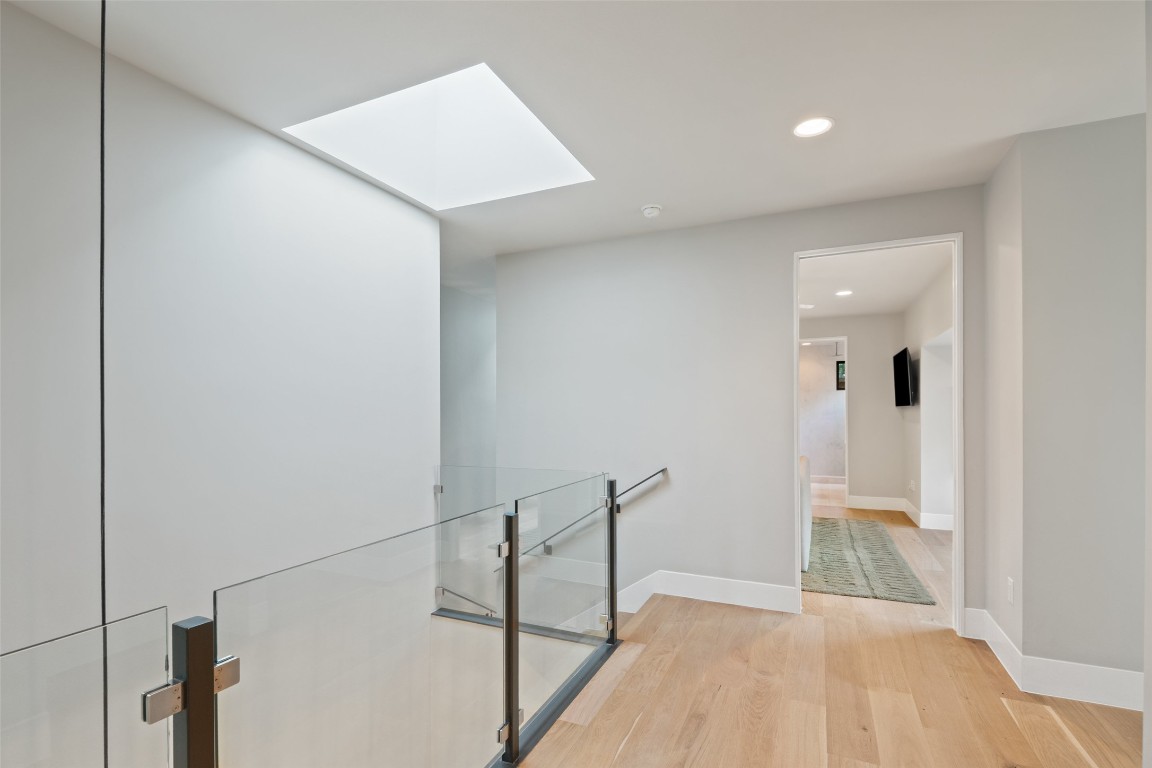 1327 Bonham Terrace, Unit B Austin, TX 78704 - Photo 25 of 40 a view of a hallway with wooden floor and staircase