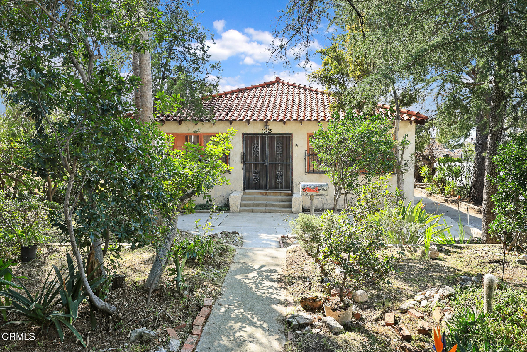 10425 Pinyon Avenue Tujunga, CA 91042 - Photo 3 of 6 a front view of a house with a yard