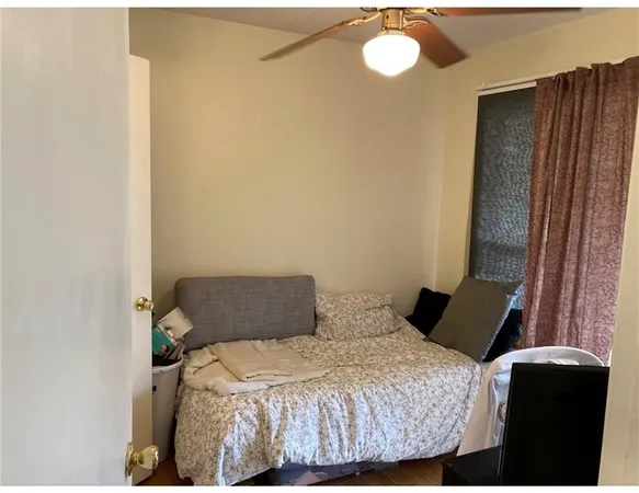 a bedroom with a bed and window