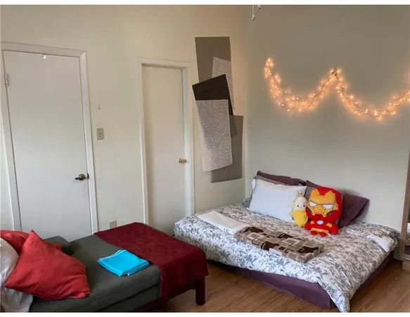 a bedroom with a bed and window