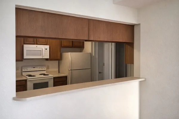 a kitchen with a refrigerator and a stove