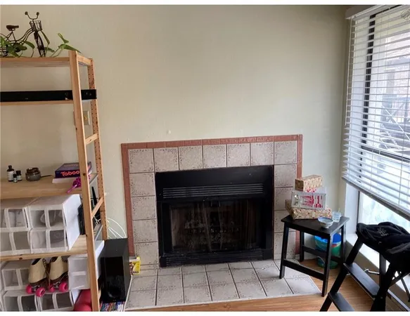 a living room with furniture a fireplace and a window