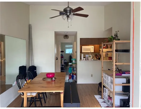 a living room with furniture and a dining table