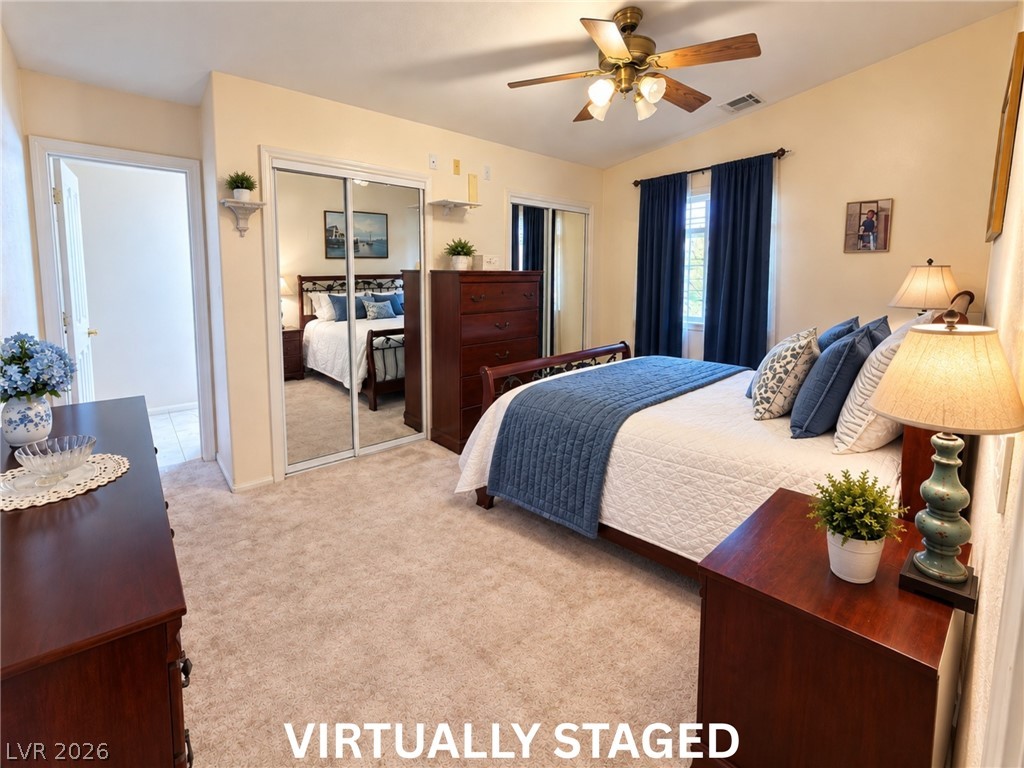 5470 Grain Mill Road Pahrump, NV 89061 - Photo 34 of 80 VIRTUALLY STAGED A spacious bedroom features neutral carpet and mirrored closet doors.