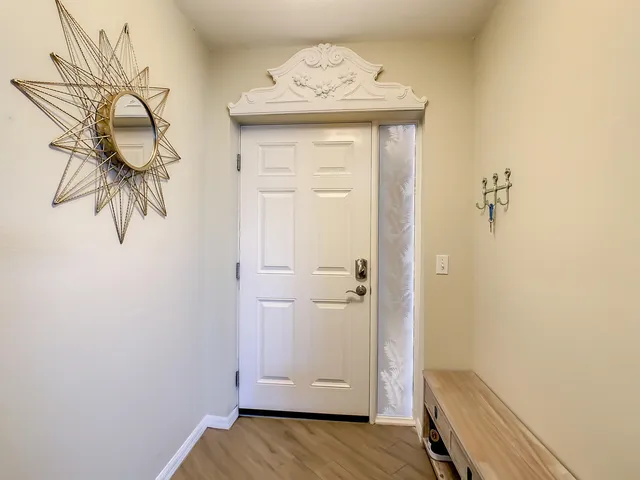 a kitchen with granite countertop wooden cabinets stainless steel appliances and a window