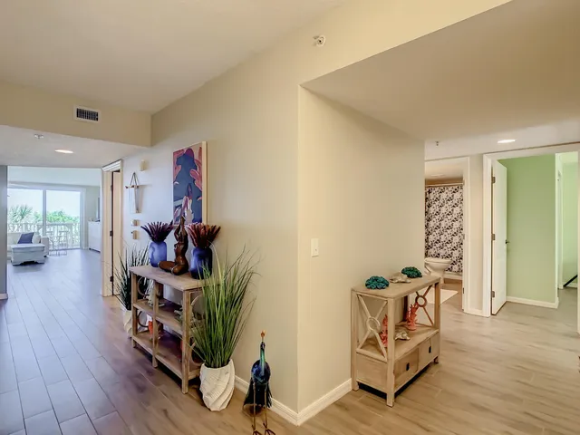 a kitchen with stainless steel appliances a stove a sink and white cabinets