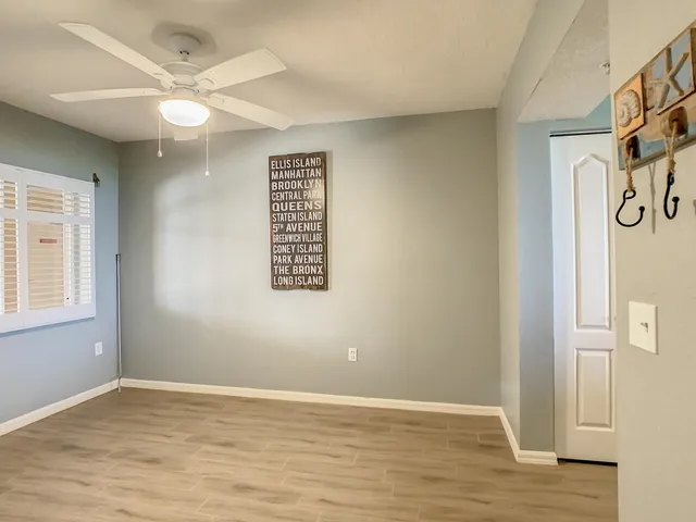 a view of a dining room with furniture wooden floor and a chandelier