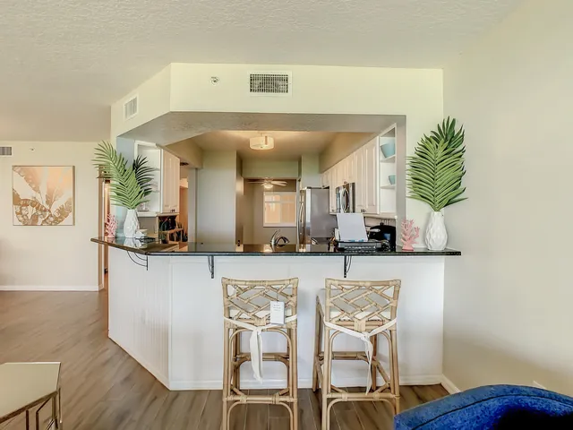 a spacious bedroom with a bed a flat screen tv and a large window