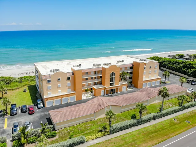 a view of a hallway with wooden floor and closet