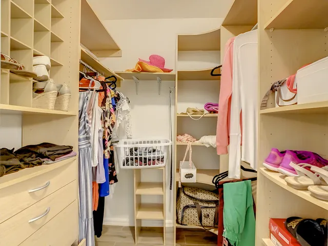 a view of a big building with a big yard and large trees