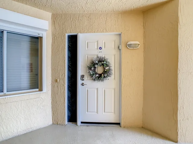 a kitchen with granite countertop a sink cabinets stainless steel appliances and a large window