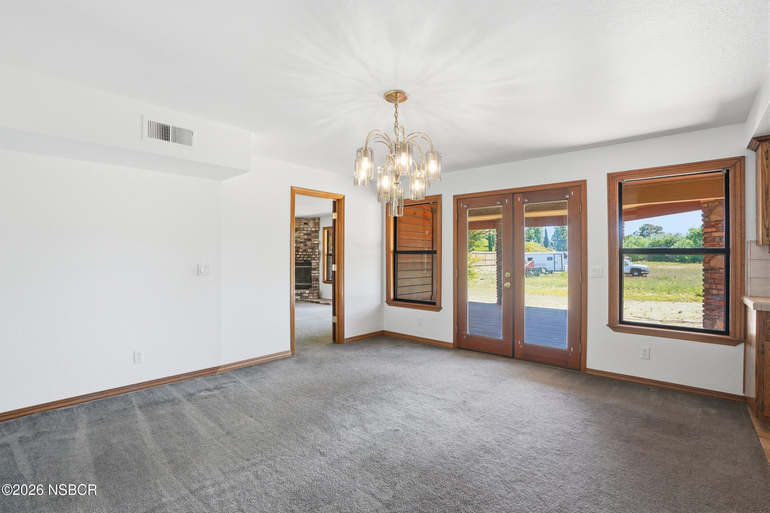 140 East Rice Ranch Road Santa Maria, CA 93455 - Photo 19 of 44 an empty room with windows and chandelier