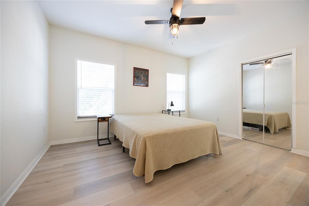 4850 Southwest 91 Terrace, Unit P201 Gainesville, FL 32608 - Photo 18 of 33 a spacious bedroom with a bed and a window