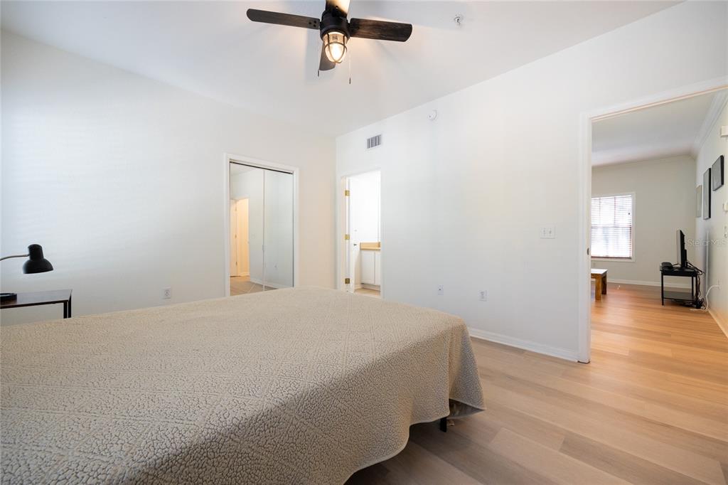 4850 Southwest 91 Terrace, Unit P201 Gainesville, FL 32608 - Photo 19 of 33 a bedroom with a bed and wooden floor