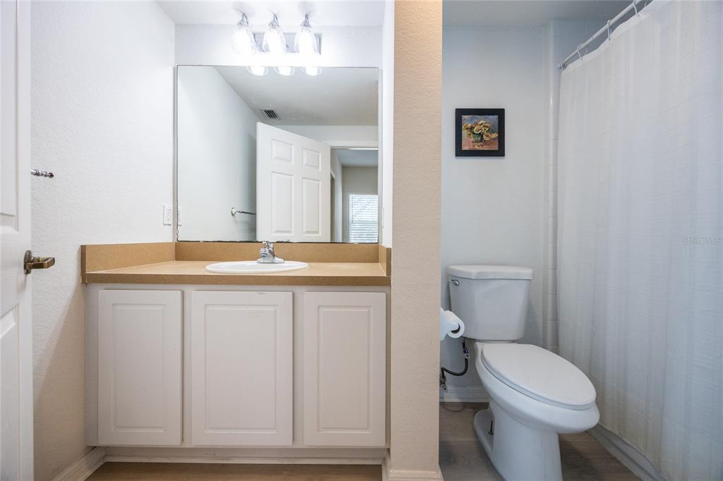 4850 Southwest 91 Terrace, Unit P201 Gainesville, FL 32608 - Photo 23 of 33 a bathroom with a toilet sink and mirror