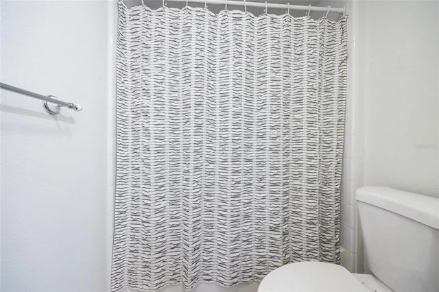 a view of a roof deck with couches chairs and wooden floor